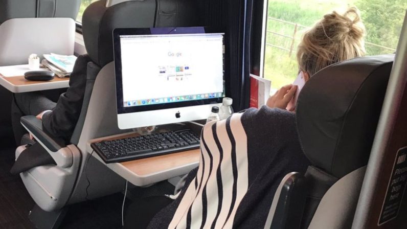 First Class Virgin Train becomes Office as Woman uses Desktop Computer