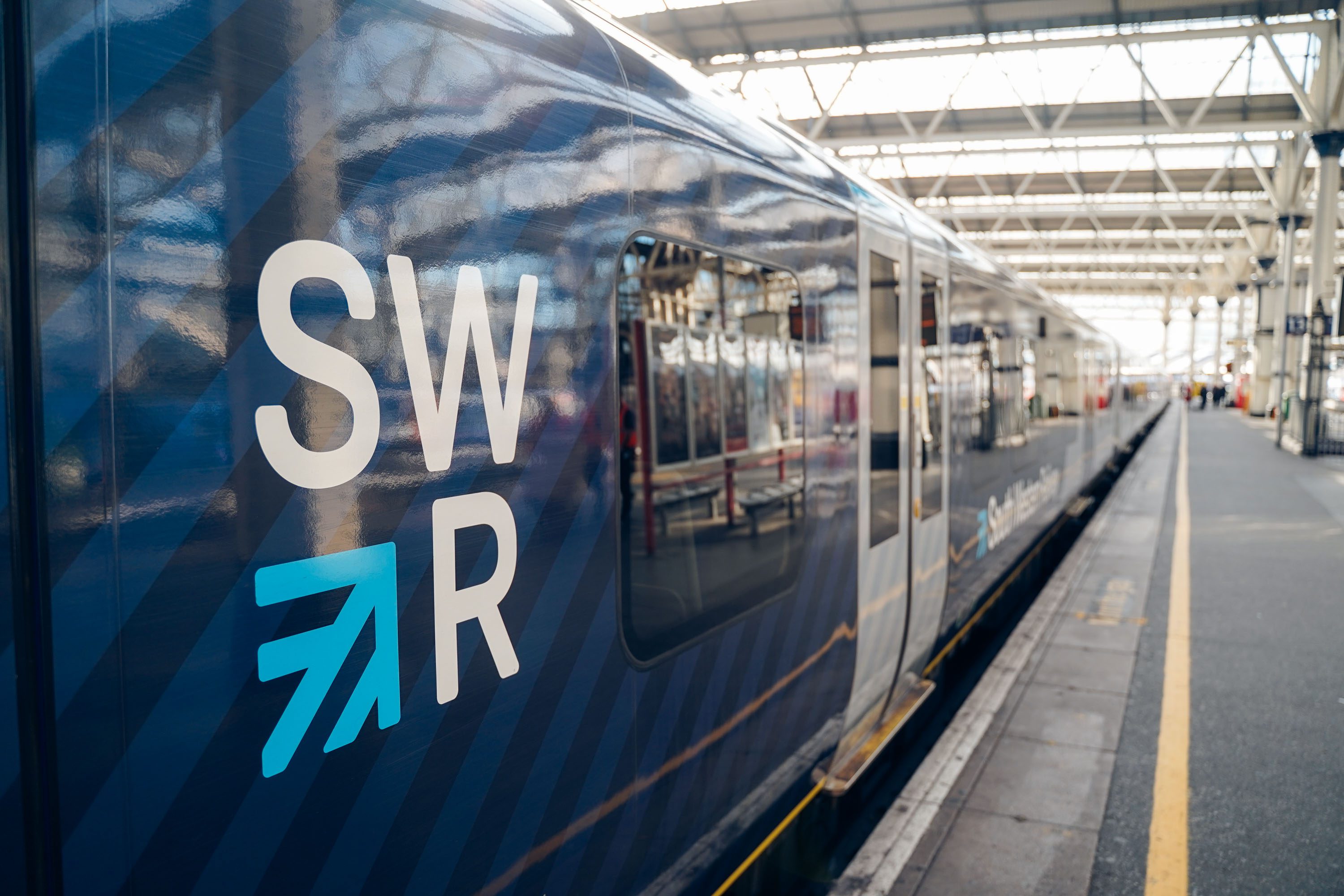 Photo of a blue SWR train on a platform with SWR logo visible