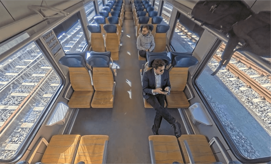 Passengers on a commuter train, as seen through the onboard surveillance cameras