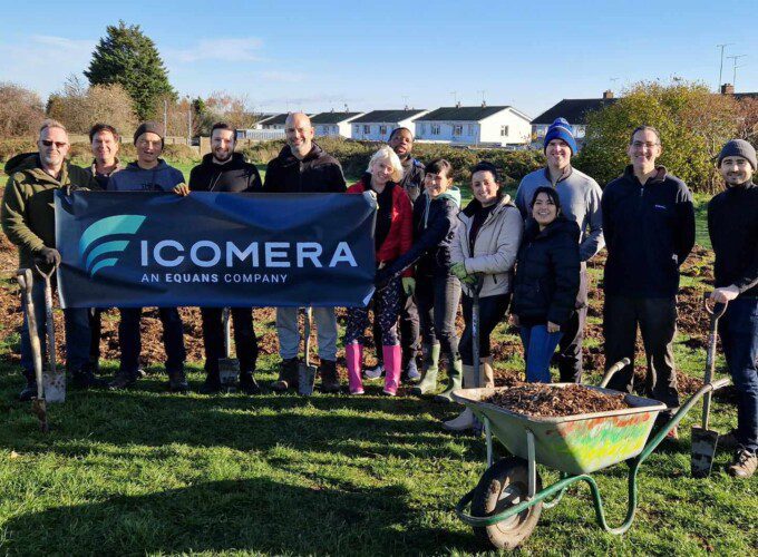 The Icomera team pose with a banner at Stonehill Park, Medway