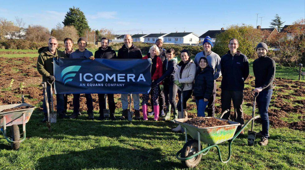 The Icomera team pose with a banner at Stonehill Park, Medway