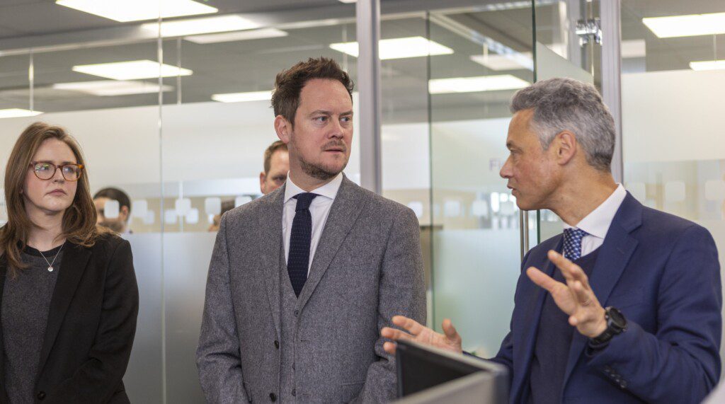 Stephen Morgan MP and Councillor Lauren Edwards in conversation with Icomera's Peter Kingsland during their tour of Icomera's UK HQ.