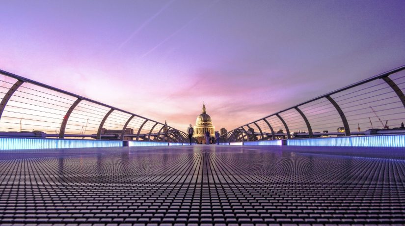 A view of London at dusk, St Paul's Cathedral is visible at the end of the Millenium Bridge