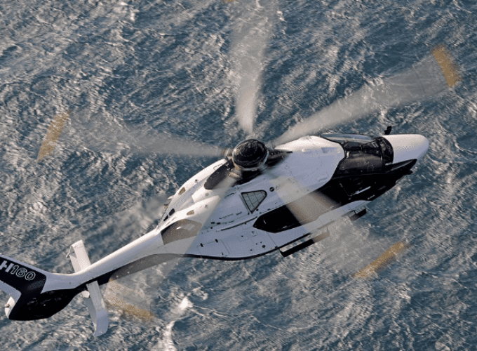 An Airbus H160 helicopter flying over the sea. Note: This was not the same helicopter model used for the trial