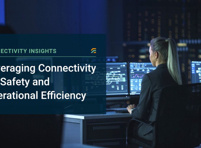 A female worker in front of several computer monitors analysing data