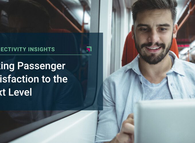 A male passenger on a train uses a tablet.